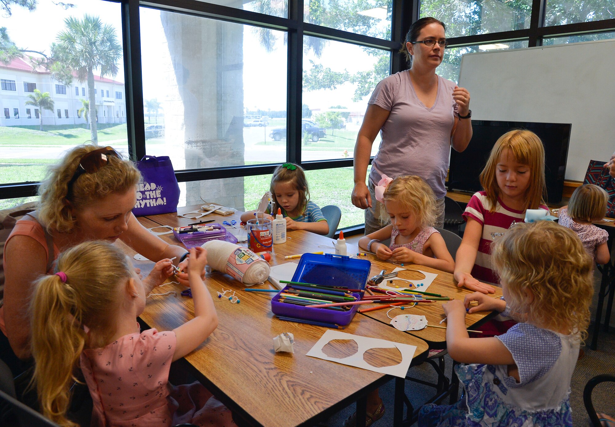 Members of Team MacDill and their children build crafts during the Children’s Summer Reading Program kick-off in the base library at MacDill Air Force Base, Fla., June 9, 2015. The kick-off consisted of arts and crafts, games, prizes and reading. (U.S. Air Force photo by Staff Sgt. Shandresha Mitchell/Released)