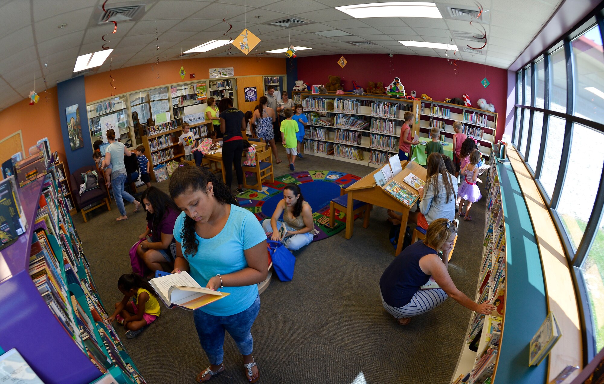 Members of Team MacDill and their families attend the Children’s Summer Reading Program kick-off in the base library at MacDill Air Force Base, Fla., June 9, 2015. The concept of the program is for children to log the books they read in order to be entered into various drawings for grand prizes, such as stuffed animals and books. (U.S. Air Force photo by Staff Sgt. Shandresha Mitchell/Released)