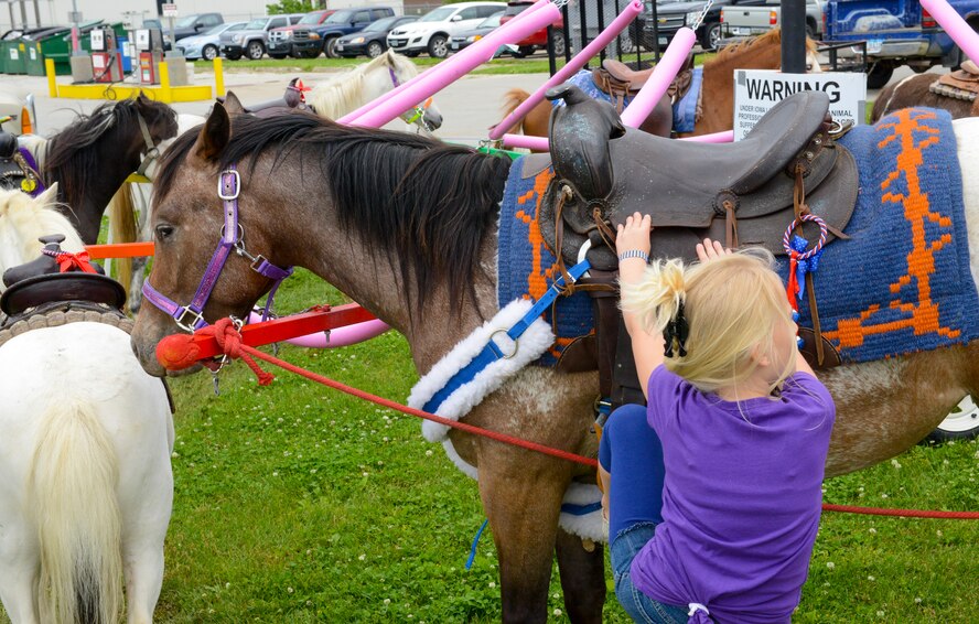 Members of the 132d Wing (132WG), Des Moines, Iowa and their families participate in the 2015 Annual Family Day held at the 132WG on Saturday, June 6, 2015. A child mounts a pony during the 2015 Family Day at the 132d Wing.  (U.S. Air National Guard photo by Senior Airman Michael J. Kelly/Released)