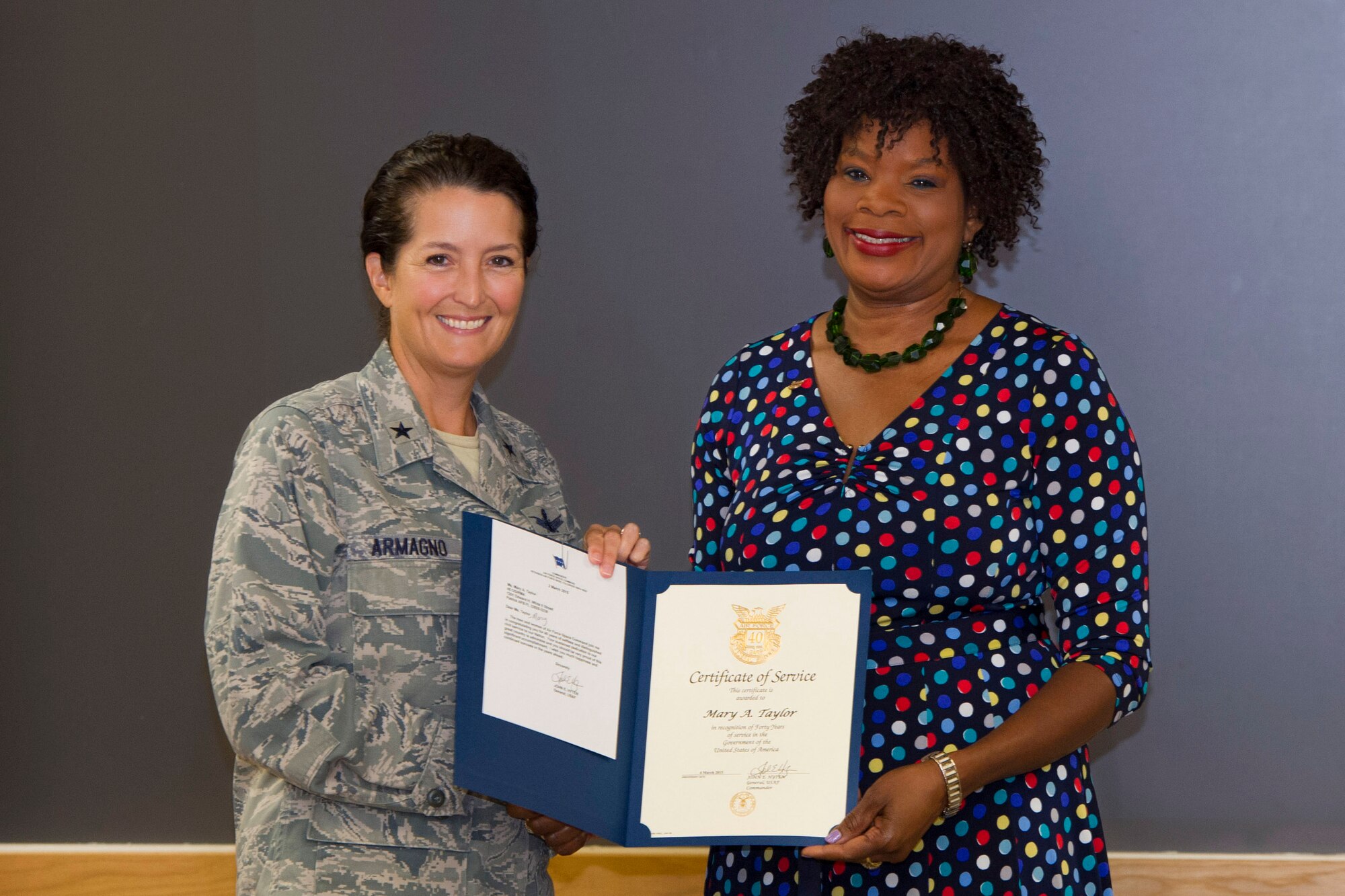 Brig. Gen. Nina Armagno, 45th Space Wing commander, presents Mary Taylor, 45th Space Wing program analyst, with a certificate in recognition of 40 years of federal service, June 10, 2015, at Patrick Air Force Base, Fla.  Taylor served on active duty for 13 years and has worked in civil service for 27 years. (U.S. Air Force photo/Matthew Jurgens) (Released) 