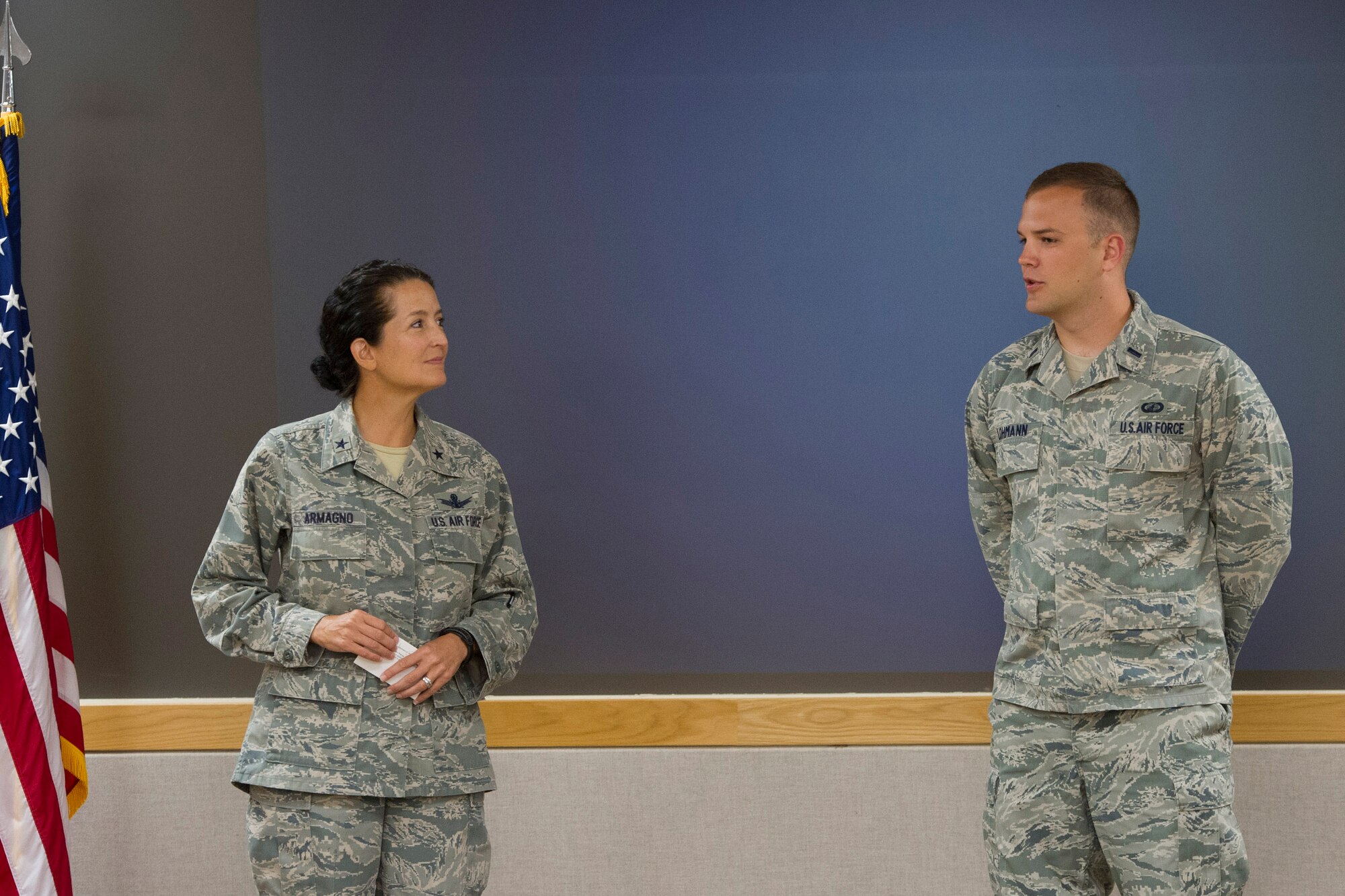 Brig. Gen. Nina Armagno, 45th Space Wing commander, recognizes 1st Lt. Tyler Lohmann, 45th Launch Support Squadron responsible engineer, during Wing Stand Up and presented him with a coin, June 10, 2015, at Patrick Air Force Base, Fla. Lohmann was recognized for ensuring mission success by immediately correcting a miscalculation in the amount of fuel needed for a space vehicle. (U.S. Air Force photo/Matthew Jurgens) (Released)
