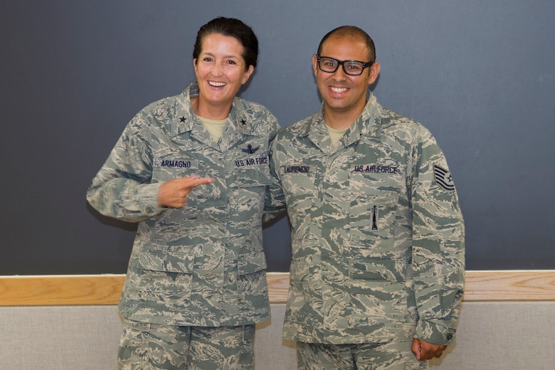 Brig. Gen. Nina Armagno, 45th Space Wing commander, thanks Tech. Sgt. Carlos Laurencio, 5th Space Launch Squadron mission assurance technician, for sharing his lessons learned in protecting personal information, June 10, 2015, at Patrick Air Force Base, Fla. When the NCO began researching how to eliminate his personal information from a variety of websites he discovered a Florida bill, which recently became state law to protect service members. He started with his journey to cyber freedom and then invested in others by sharing his "behind the scenes" training session to help other Wingmen be aware of ways to protect their information. (U.S. Air Force photo/Matthew Jurgens) (Released) 