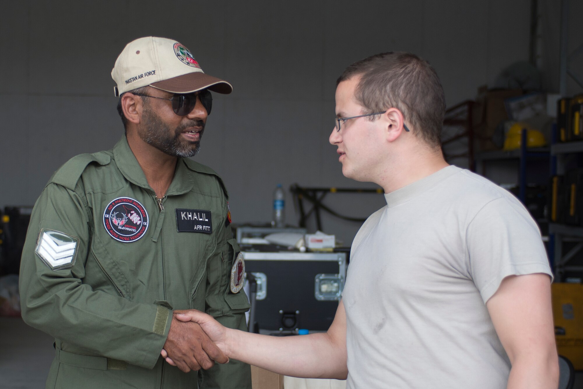 U.S. Air Force Senior Airman Alex Ross, 748th Aircraft Maintenance Squadron, right, shakes hands with a crew chief from the Pakistan Air Force during Anatolian Eagle 15 at 3rd Main Jet Base, Turkey, June 10, 2015. Anatolian Eagle is a two-week flying training exercise involving U.S. Air Forces in Europe units and multiple NATO partners. (U.S. Air Force photo by Tech. Sgt. Eric Burks/Released)