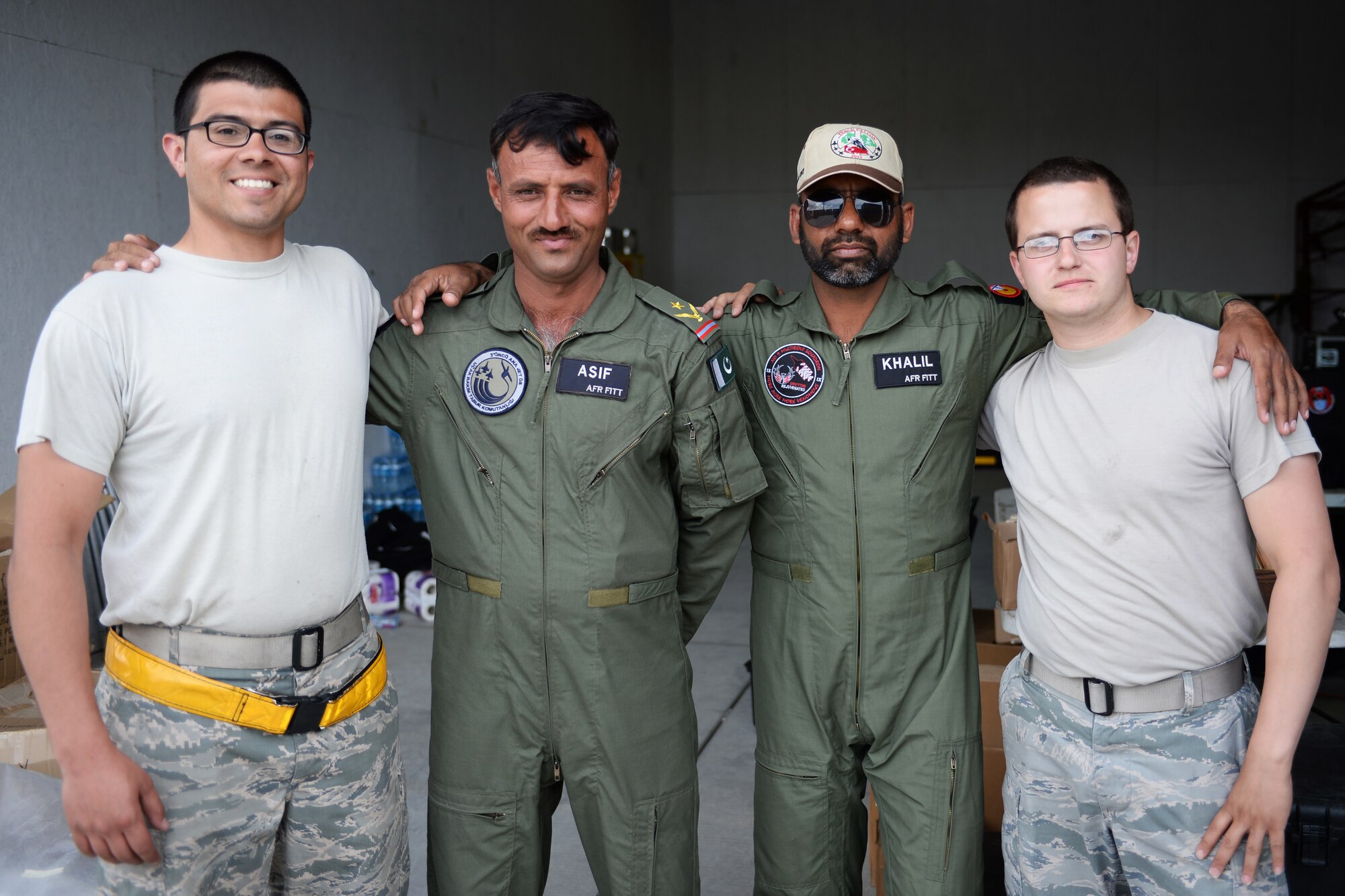 U.S. Air Force Staff Sgt. Jesus Trevino, far left, and Senior Airman Alex Ross, far right, both 748th Aircraft Maintenance Squadron, pose for a photo with Pakistan Air Force crew chiefs during Anatolian Eagle 15 at 3rd Main Jet Base, Turkey, June 10, 2015. Anatolian Eagle is a two-week flying training exercise involving U.S. Air Forces in Europe units and multiple NATO partners. (U.S. Air Force photo by Tech. Sgt. Eric Burks/Released)