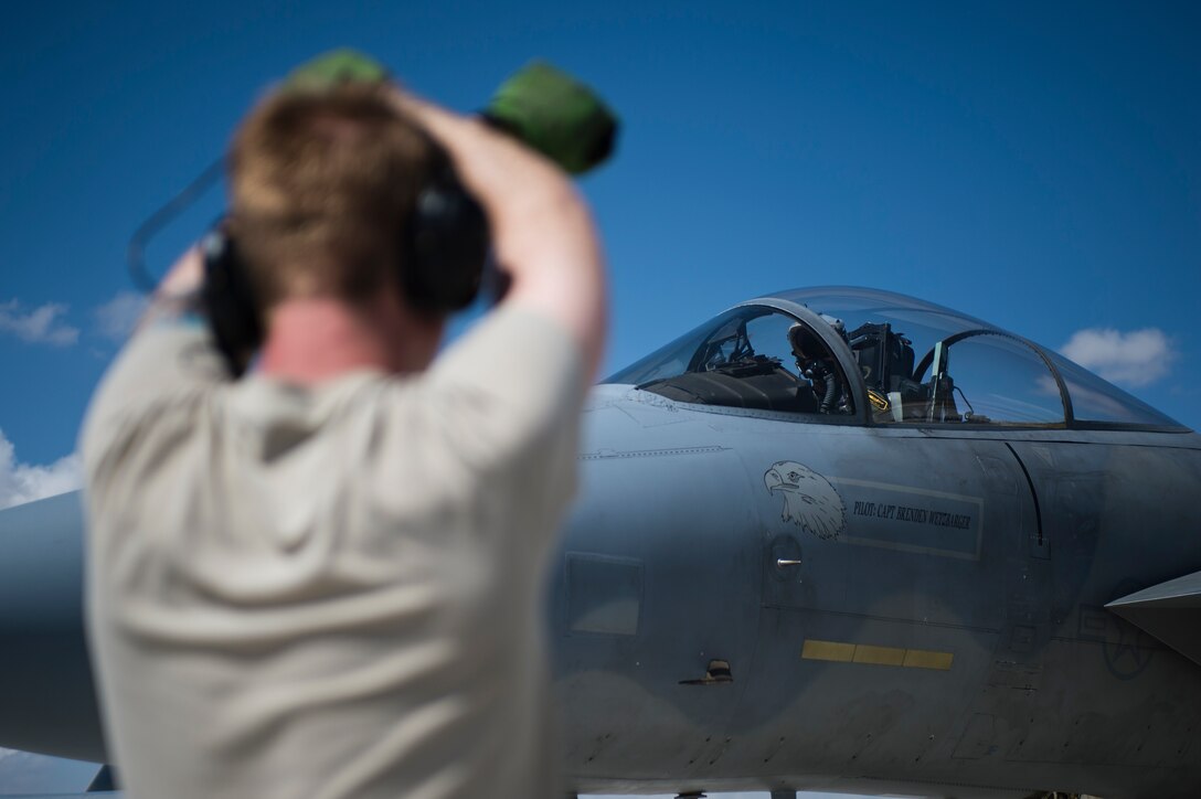 An Airman assigned to the 748th Aircraft Maintenance Squadron signals to a 493rd Fighter Squadron pilot in an F-15C Eagle prior to takeoff during Anatolian Eagle 15 at 3rd Main Jet Base, Turkey, June 10, 2015. Approximately 250 personnel and 12 F-15 aircraft from the 48th Fighter Wing, Royal Air Force Lakenheath, England, are participating in the two-week exercise. (U.S. Air Force photo by Tech. Sgt. Eric Burks/Released)