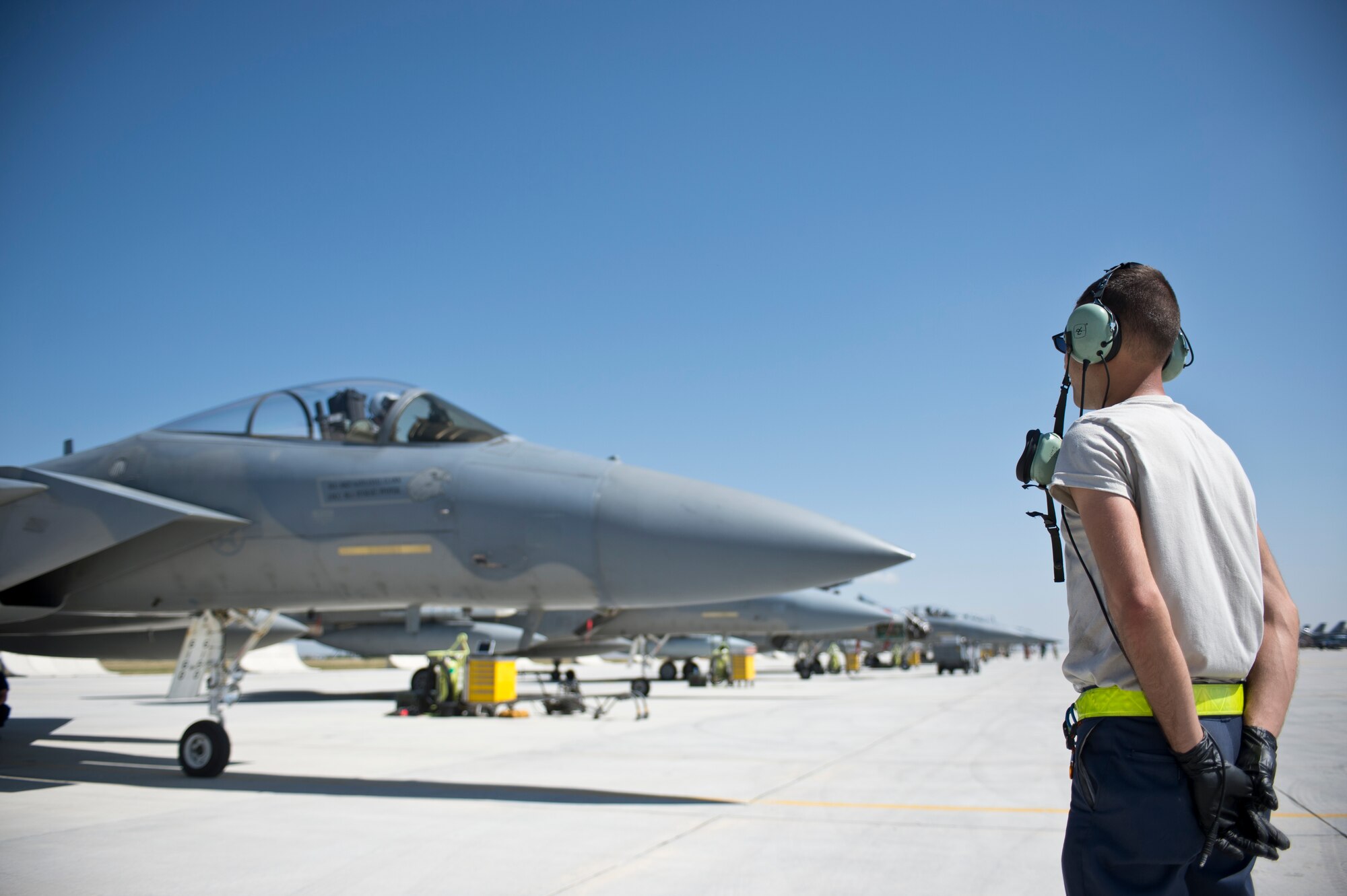 A 748th Aircraft Maintenance squadron Airman stands near a row of F-15 Eagles from the  493rd Fighter Squadron, Royal Air Force Lakenheath, England, prior to a mission during Anatolian Eagle 15 at 3rd Main Jet Base, Turkey, June 10, 2015. Approximately 250 personnel and 12 F-15 aircraft from the 48th Fighter Wing, RAF Lakenheath, England, are participating in the two-week exercise. (U.S. Air Force photo by Tech. Sgt. Eric Burks/Released)