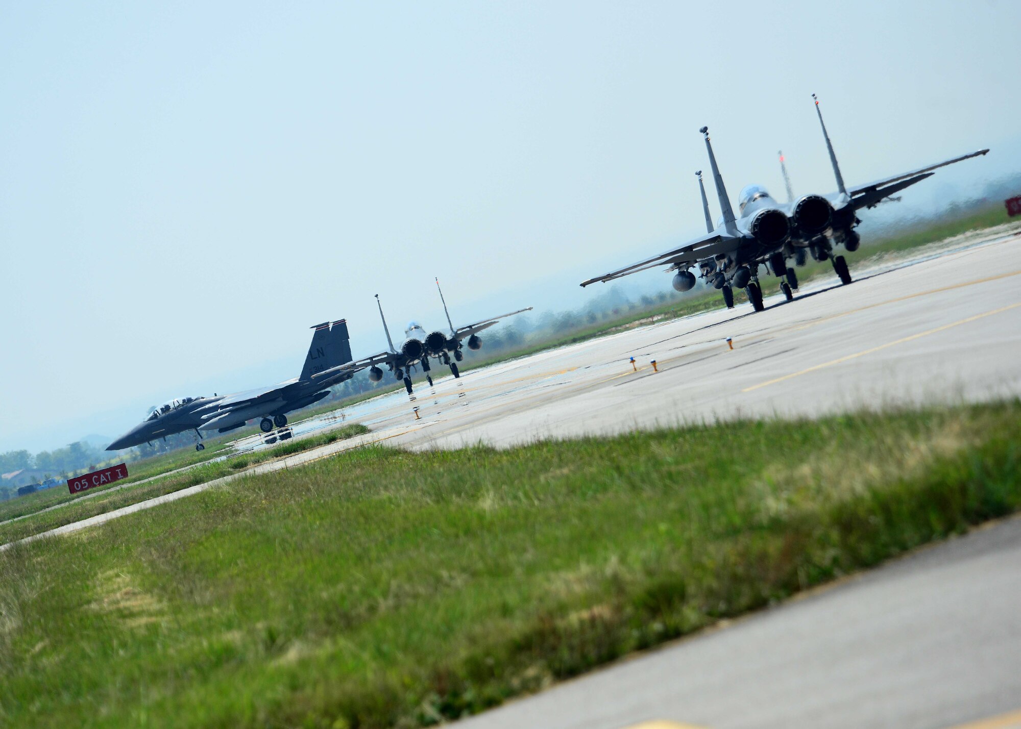 A group of F-15E Strike Eagles assigned to the 492nd Fighter Squadron at Royal Air Force Lakenheath, England, taxi down a runway, June 3, 2015, at Aviano Air Base, Italy. More than 300 personnel visited Aviano to conduct multiple training exercises with 510th FS. (U.S. Air Force photo by Airman 1st Class Deana Heitzman/Released)
 
