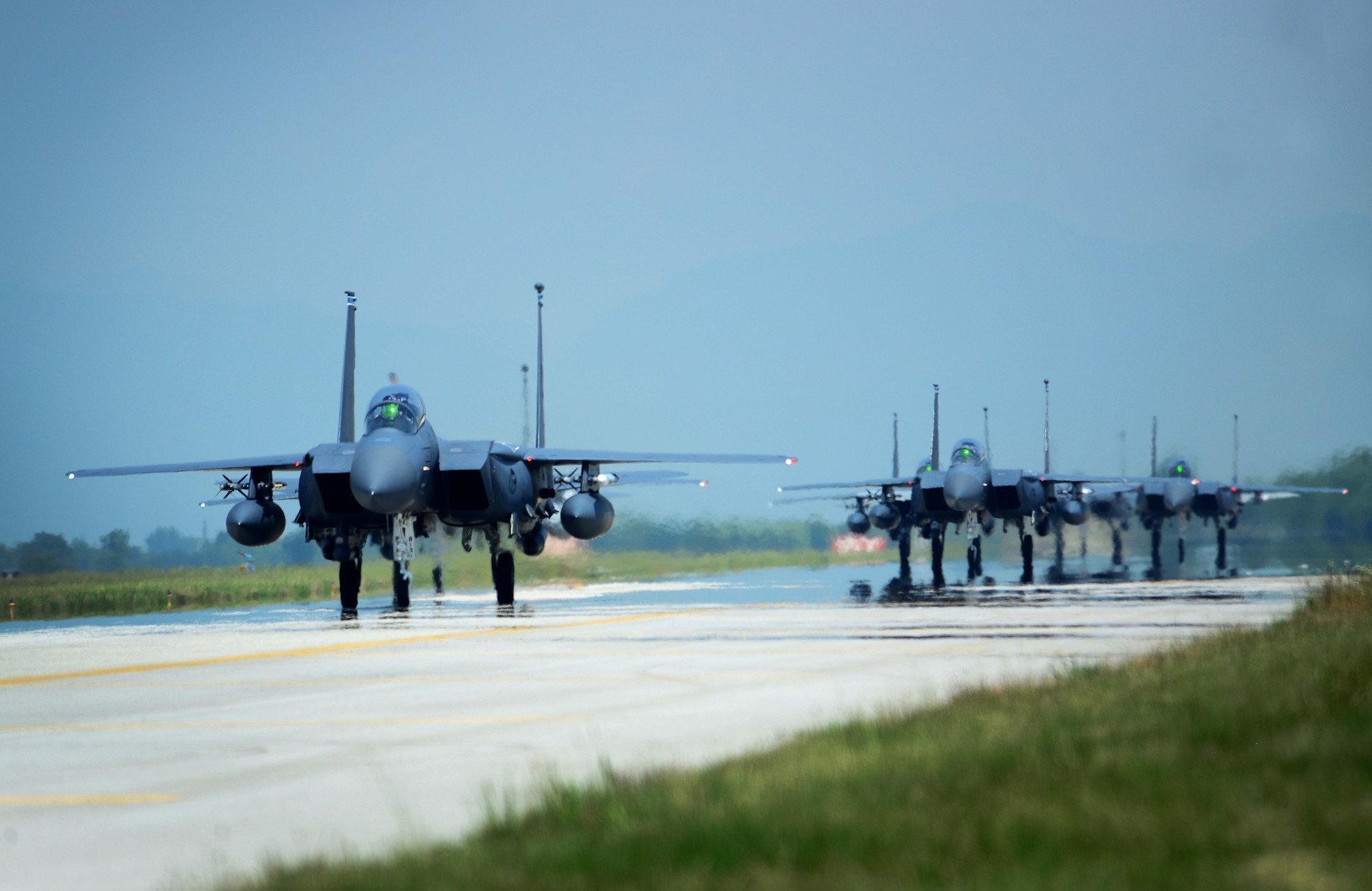 A group of F-15E Strike Eagles assigned to the 492nd Fighter Squadron at Royal Air Force Lakenheath, England, taxi down a runway, June 3, 2015, at Aviano Air Base, Italy. More than 300 personnel visited Aviano to conduct multiple training exercises with the 510th FS. (U.S. Air Force photo by Airman 1st Class Deana Heitzman/Released)