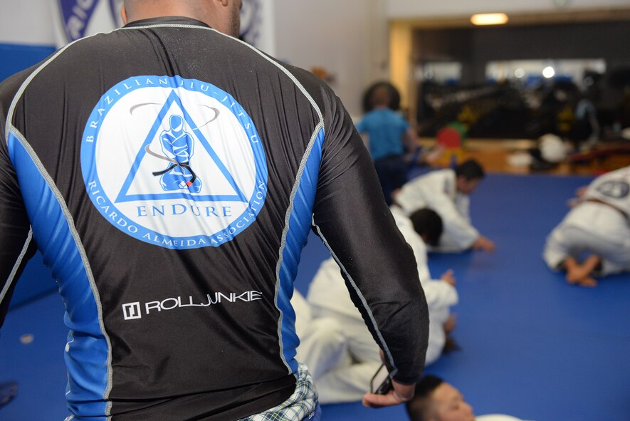 Master Sgt. Bob Williams, jiu-jitsu instructor, supervises his students as they spar at Yokota Air Base, Japan, June 10, 2015. Williams is a first degree black belt who has been practicing jiu-jitsu since 2009. (U.S. Air Force photos by Airman 1st Class Elizabeth Baker/Released)