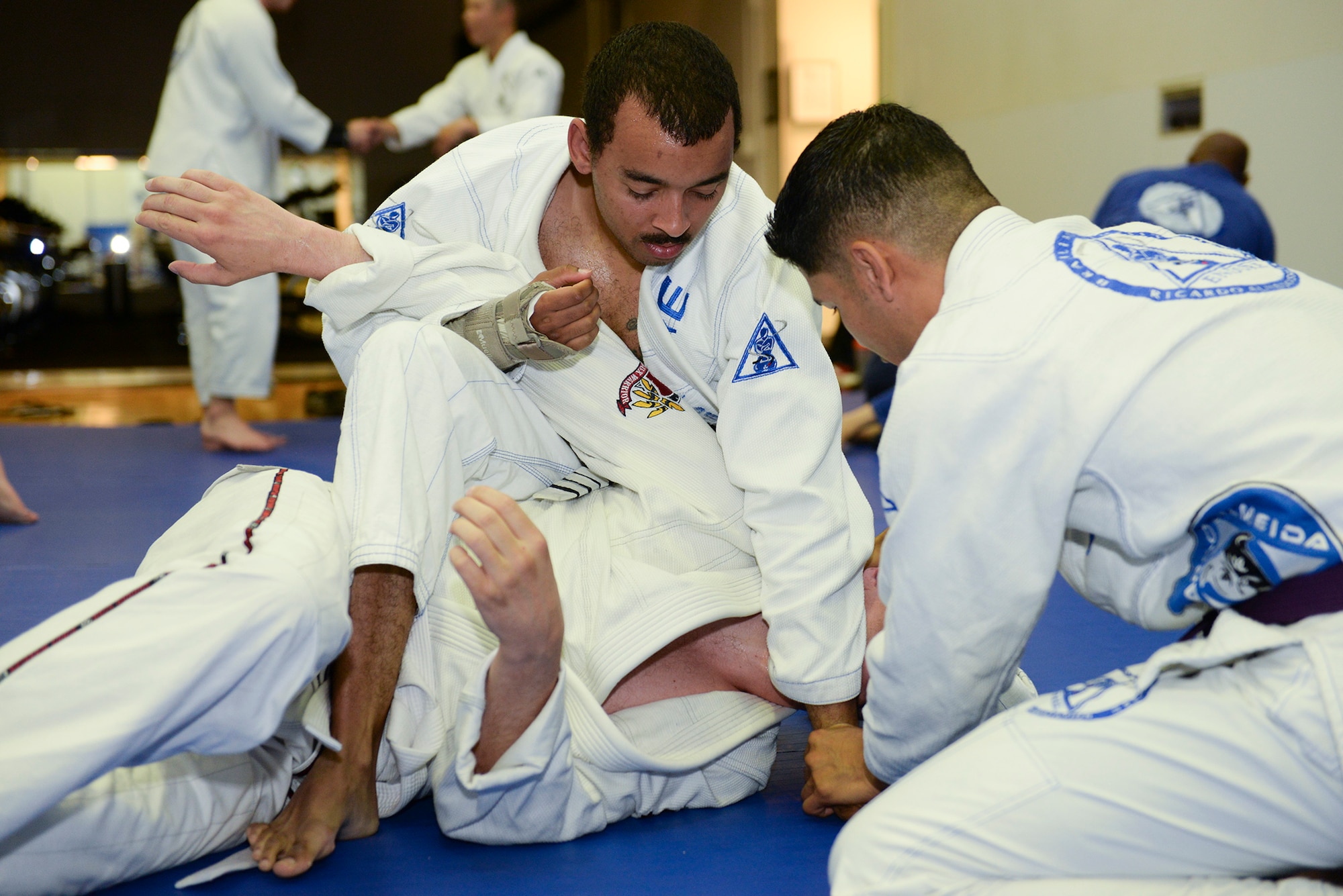 A student gives instructions to others at Endure, a jiu-jitsu class at Yokota Air Base, Japan, June 10, 2015. After warming up, students paired off and took turns practicing various maneuvers. (U.S. Air Force photos by Airman 1st Class Elizabeth Baker/Released)