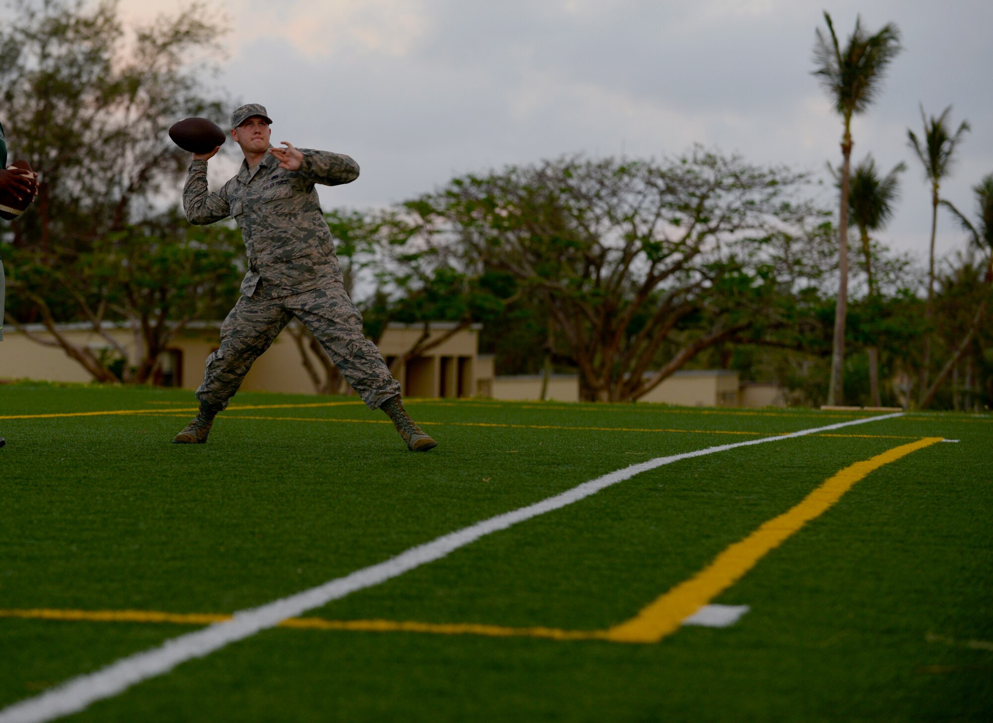 Senior Airman Presley Griffith, 36th Mobility Response Squadron executive assistant, passes a football June 6, 2015, at Andersen Air Force Base, Guam. Griffith created a free spring practice camp as volunteer coach and is working to become a history teacher and high school football coach. (U.S. Air Force photo by Senior Airman Alexander W. Riedel/Released)