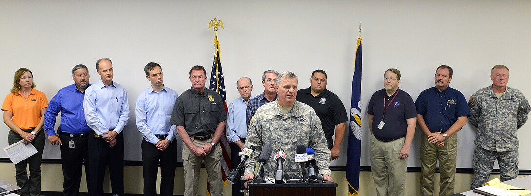 Army Maj. Gen. Glenn H. Curtis, center, adjutant general of the Louisiana National Guard, speaks during a press conference on flood-prevention and recovery efforts in Bossier City, La., June 9, 2015.