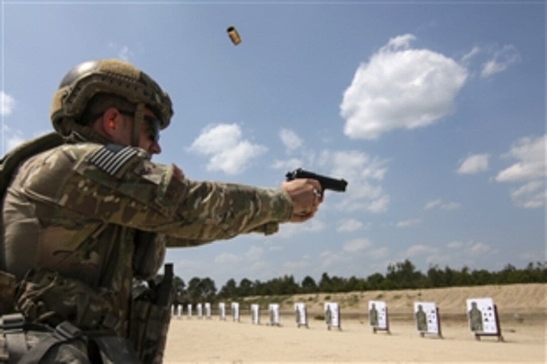 Air Force Senior Airman Chris Whitehurst shoots an M9 pistol during qualifications on Joint Base McGuire-Dix-Lakehurst, N.J., June 10, 2015. Whitehurst is assigned to the New Jersey Air National Guard's 227th Air Support Operations Squadron.
