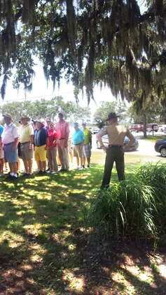 Sgt. Jonathan Owens, senior drill instructor assigned to Recruit Processing Company, Support Battalion, greets golfers before a tournament at the Legends at Parris Island golf course June 8, 2015. The "receiving" tournament was the first of four scheduled tournaments leading up to the celebration of Parris Island's centennial anniversary in October.