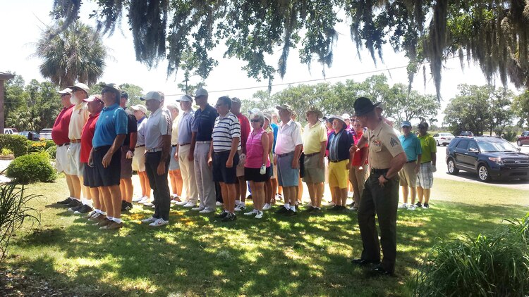 Sgt. Jonathan Owens, senior drill instructor assigned to Recruit Processing Company, Support Battalion, greets golfers before a tournament at the Legends at Parris Island golf course June 8, 2015. The "receiving" tournament was the first of four scheduled tournaments leading up to the celebration of Parris Island's centennial anniversary in October.
