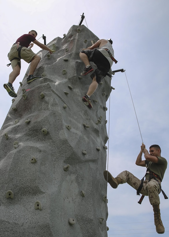 Marines with 2nd Marine Headquarters Group, II Marine Expeditionary Force, compete in a rock climbing race during the unit’s Beach Bash where Marines and their families came together to relax and enjoy some healthy competition on Onslow Beach aboard Camp Lejeune, N.C., June 10, 2015. Col. Thomas J. Gordon, the commanding officer of 2nd MHG, explained that the unit would not be able to operate at the high level of readiness that it does without the support of the Marines’ families and that this event was meant to reward them for their hard work and dedication to mission accomplishment. (U.S. Marine Corps photo by Cpl. Michelle Reif/Released.)