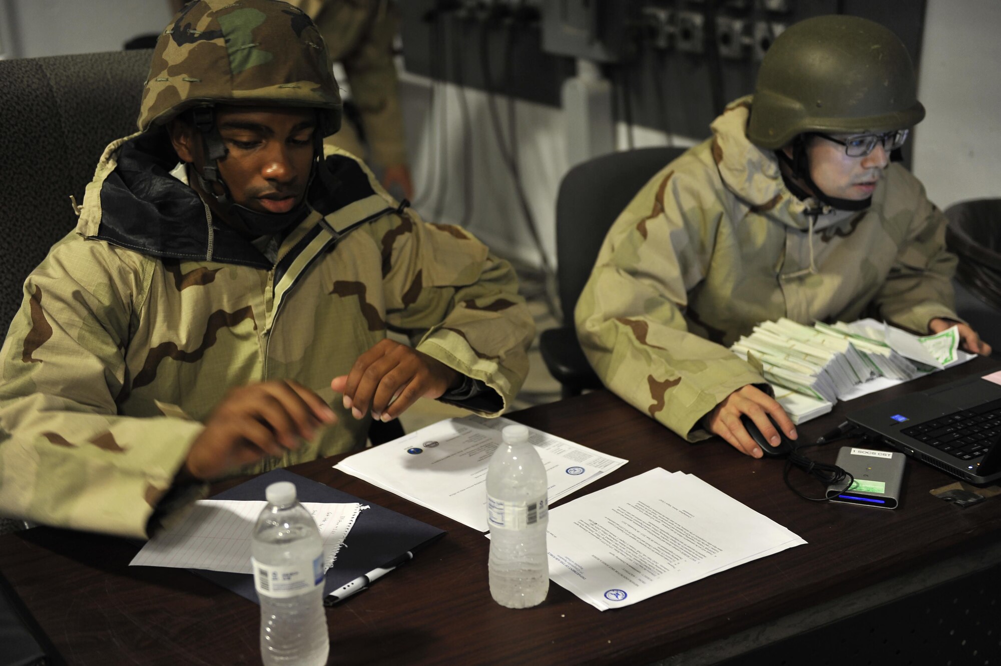 Senior Airman Jonathan Chapman and Staff Sgt. Joshua Reber, assigned to the 1st Special Operations Comptroller Squadron, count ‘cash’ and review the end of day cash accountability during the Financial Management Warrior expeditionary exercise on Hurlburt Field, Fla., June 6, 2015. The training is based on ‘Top Dollar,’ a finance exercise from the 1990’s, and is anticipated to become an annual or semi-annual training event for Eglin and Hurlburt Airmen. (U.S. Air Force photo/Amn Kai White)