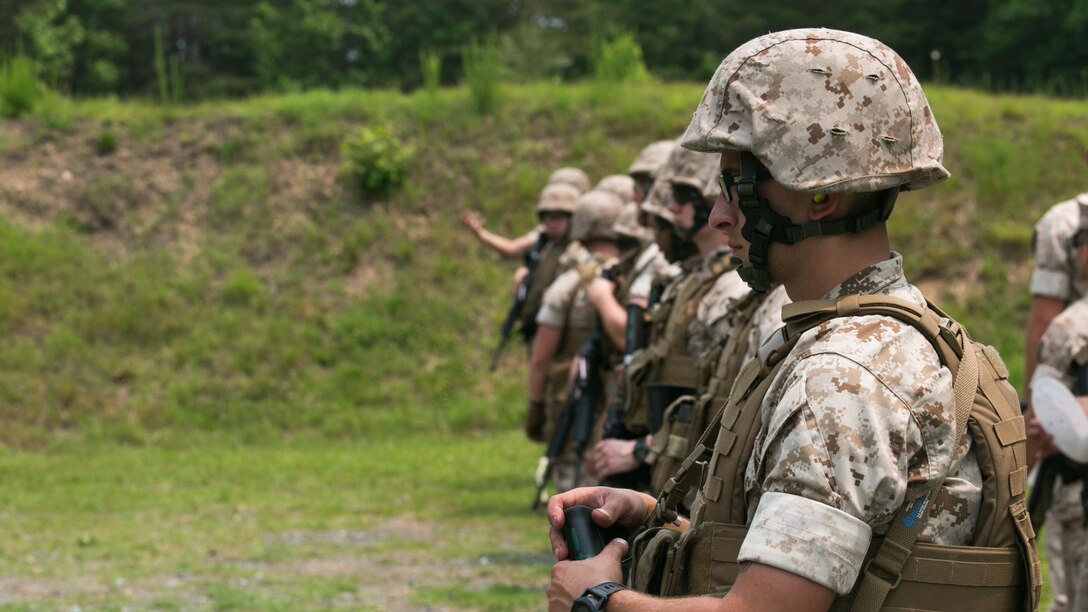 Guard Marines from Marine Barracks Washington, stand on the firing line during a training exercise at Range 5, Marine Corps Base Quantico, Virginia, June 10, 2015. 1st platoon, Guard Company, traveled there to increase overall marksmanship with the M9 service pistol, the M4 service rifle and M1014 shotgun. “By the time these Marines leave Guard Company we are hoping that they have mastered the fundamentals of marksmanship,” said Capt. Greg Jurschak, 1st platoon commander, Guard Co. “We also want to hone their decision making and judgment skills. It’s not only having good fundamentals it is knowing the right place, the right time and the right reason to actually employ their weapons.”