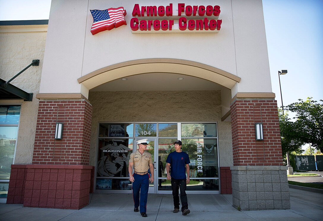 Sgt. Cody Leifheit, a Marine recruiter in Lewiston, Idaho, speaks with enlistee Luke Ellsworth while departing his recruiting office June 10, 2015. Leifheit, a 28-year-old infantry Marine from Ferndale, Washington, responded to a 19-year-old man hanging himself from a tree outside his house June 7. Without hesitation, Leifheit climbed up the tree 25 feet and took hold of the man, who wasn’t breathing and lacked a pulse. Leifheit worked to keep him alive until first responders arrived, continuously performing chest compressions as the man faded in and out. Despite spending 48 hours in a coma, the man survived. (U.S. Marine Corps photo by Sgt. Reece Lodder)