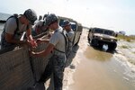 Soldiers from the Alabama National Guard build  and maintain miles of HESCO barriers to protect Dauphin Island, Ala., beaches  from the BP oil spill on July 23, 2010, during Operation Deepwater Horizon,  which saw more than 1,600 National Guardmembers support civilian authorities in  four Gulf states. The American people have come to expect swift and effective  responses to natural and manmade disasters, the chief of the National Guard  Bureau said Monday.