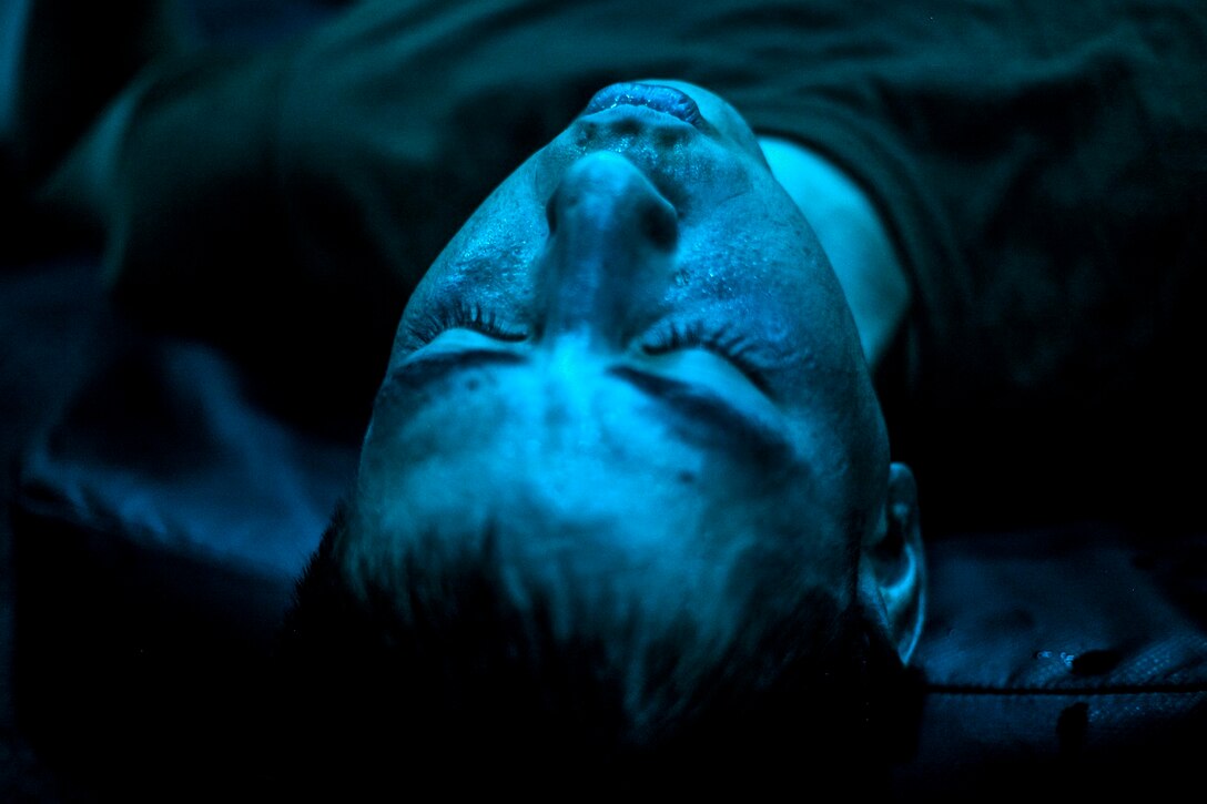 A U.S. Marine with Lima Company, Battalion Landing Team 3rd Battalion, 1st Marine Regiment, 15th Marine Expeditionary Unit, concentrates on his breathing during a body hardening session in the hangar bay of the USS Essex (LHD 2) in the Philippine Sea, June 2, 2015. The Marines are learning boxing techniques to improve their mental and physical well-being during their seven-month deployment. (U.S. Marine Corps photo by Cpl. Elize McKelvey/Released)