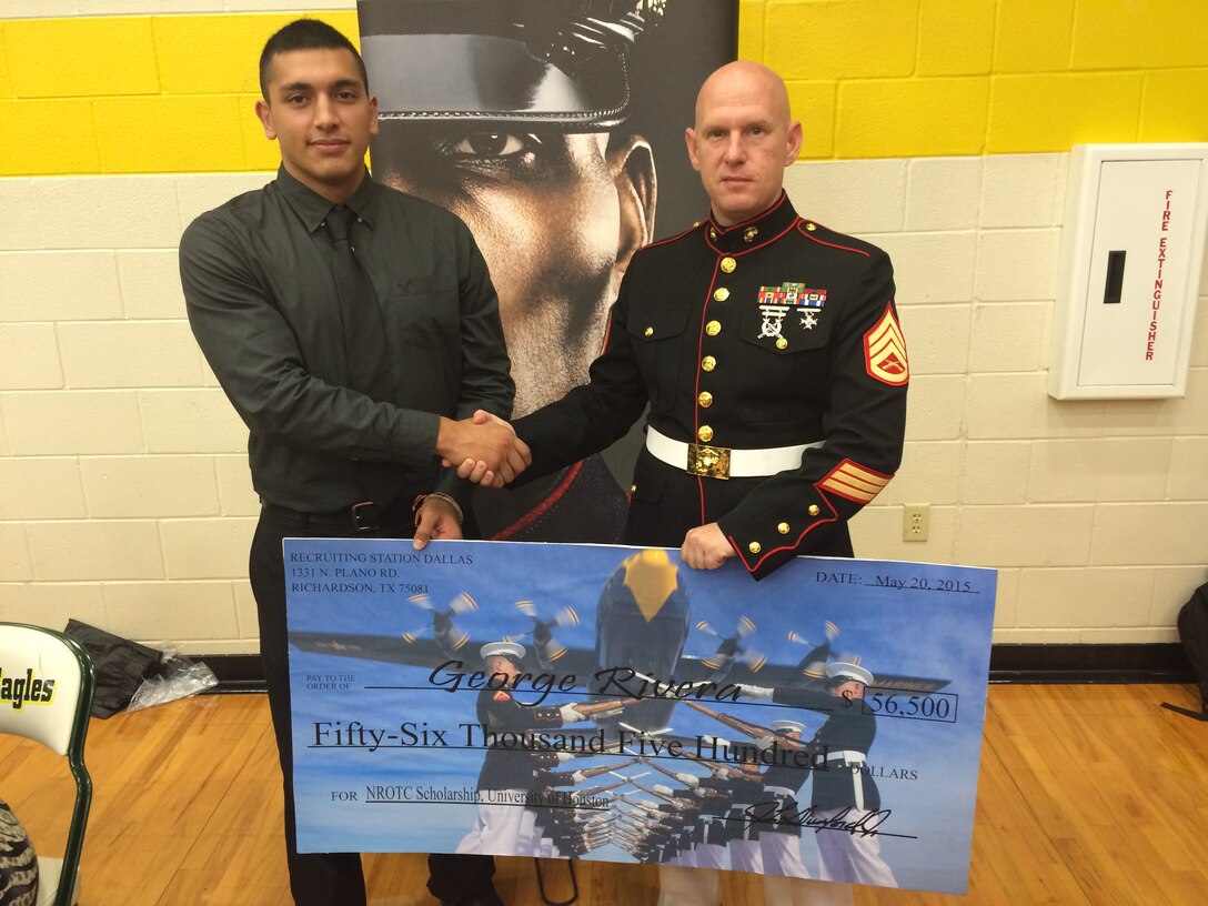 DESOTO, Texas - SSgt. Warren M. Phipps presents George Rivera a Naval
Reserve Officer Training Corps Scholarship check at Desoto High School.
Selected applicants for the NROTC Scholarship Program are awarded
scholarships through a highly competitive national selection process, and
receive full tuition, books stipend, educational fees and other financial
benefits at many of the country's leading colleges and universities. Phipps
is a recruiter with Recruiting Station Dallas. Rivera is a high school track
and field athlete, slated to attend the University of Houston in the fall.
(U.S. Marine Corps photo by Sgt. Daniel E. Valle)
