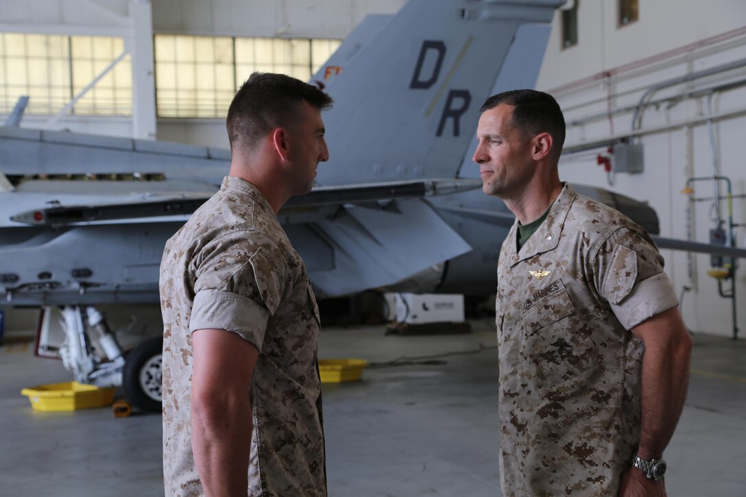 Cpl. Daniel Jacobs, left, stands at attention in front of Lt. Col. Harry Thomas Jr., as his promotion warrant is read in the Marine Fighter Attack Squadron 312 hangar, June 2. Jacobs was meritoriously promoted to corporal, assuming the responsibilities of a noncommissioned officer earlier than anticipated. Jacobs is an ordnance technician with VMFA-312, Marine Aircraft Group 31. Thomas is the commanding officer of the squadron.