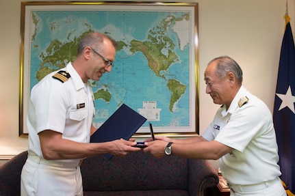 Japan Chief of Defense Adm. Katsutoshi Kawano presents Japan's Defense Cooperation Award to Cmdr. Daniel Fillion in appreciation for his work as a Japan country officer on the Joint Staff.