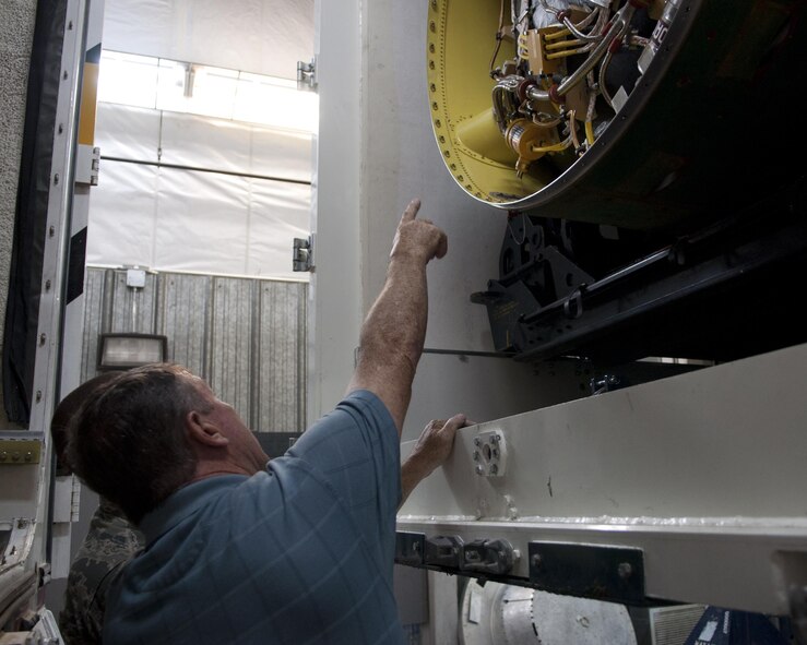 Richard Mullee, the 90th Missile Wing Safety Office missile safety superintendent, examines the midsection of the booster of the Minuteman III ICBM during the 90th Missile Maintenance Squadron’s annual weapons safety inspection June 9, 2015, on F.E. Warren Air Force Base, Wyo. Inspections play a vital part in the mission of the weapon safety office. They provide the office the opportunity to see the mission and work environment firsthand, in order to catch any issues before they worsen. (U.S. Air Force photo/Airman 1st Class Malcolm Mayfield)