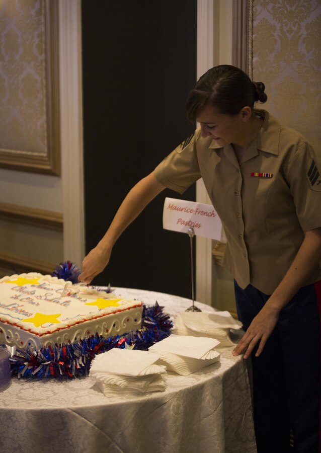 Sgt. Brytani Musick, public affairs noncommissioned officer-in-charge for Marine Forces Reserve, slices the cake at the New Orleans Chef’s Salute to Our Armed Forces hosted by the Navy League at the Bourbon Orleans Hotel, June 11, 2015, where she was recognized as Marine of the Year. For five years, chefs around New Orleans have shown support for America’s military by serving their specialty entrees to veterans free of charge, and by recognizing the enlisted service members of the year for each respective branch of the U.S. armed forces. 