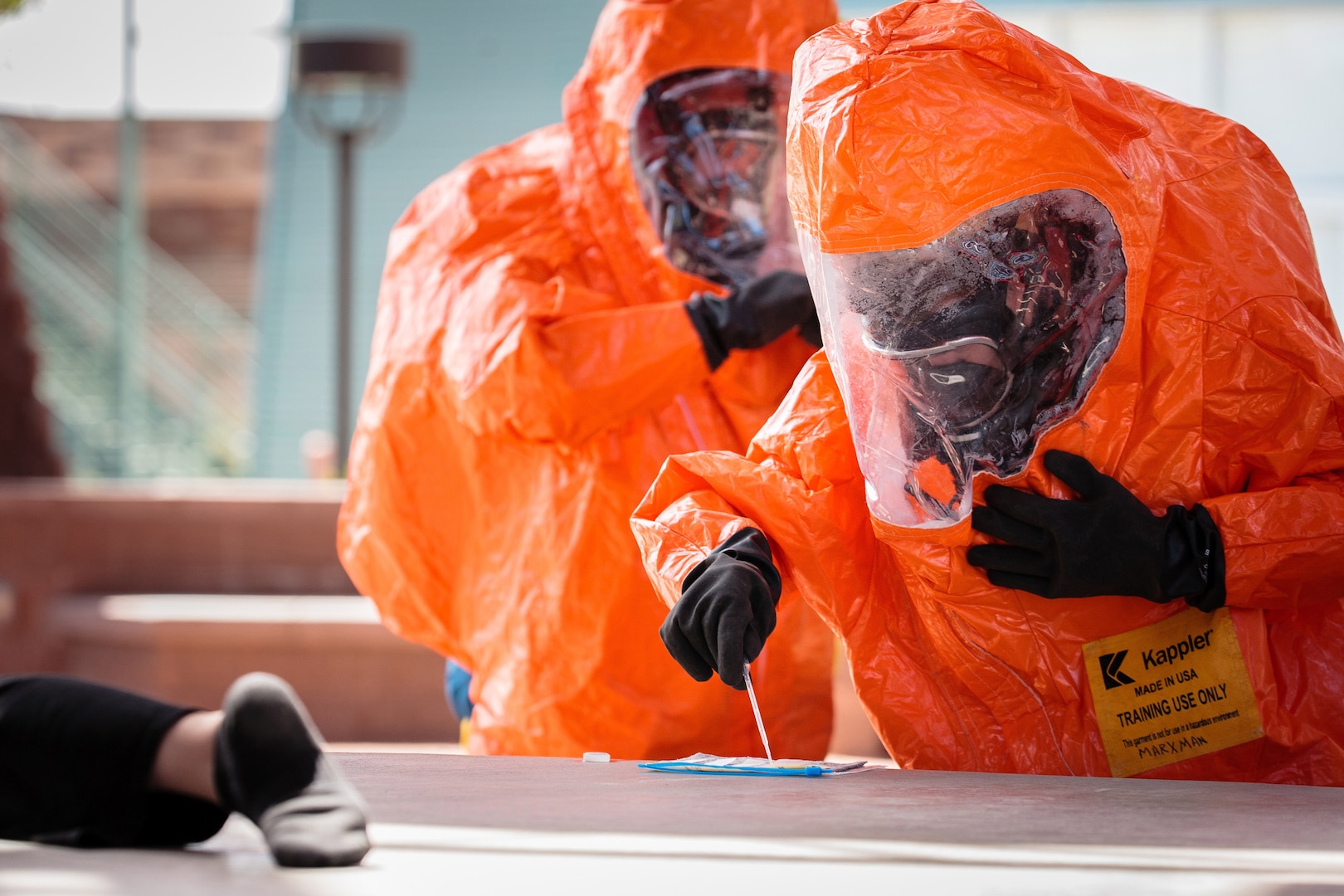 Arizona Army National Guard Sgt. Andrew Marxman, a survey team member for the 91st Civil Support Team, uses chemical detection paper to determine the basic chemical hazard of the substance during an exercise simulating a campus shooting and hazardous material release. The M-256A1 Chemical Detection Kit can be used to determine if the substance is a blood, nerve or blister agent.