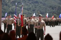 Lieutenant Col. Steven M. Sutey, newly appointed battalion commander of 1st Battalion, 1st Marine Regiment, 1st Marine Division, speaks to the Marines and loved ones of the battalion after formally receiving his command. Sutey has several past deployments with the 1st Marine Division and said he is proud to command and serve once again with the unit. (U.S. Marine Corps photo by Cpl. Carson A. Gramley/Released)