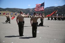 Lieutenant Col. Lance A. Jackola, previous battalion commander of 1st Battalion, 1st Marine Regiment, 1st Marine Division, and his successor Lt. Col. Steven M. Sutey, watch as the Marines and Sailors of 1st Battalion pass in review at the end of the change of command ceremony. Sutey has several past deployments with the 1st Marine Division and said he is proud to command and serve once again with the unit. (U.S. Marine Corps photo by Cpl. Carson A. Gramley/Released)