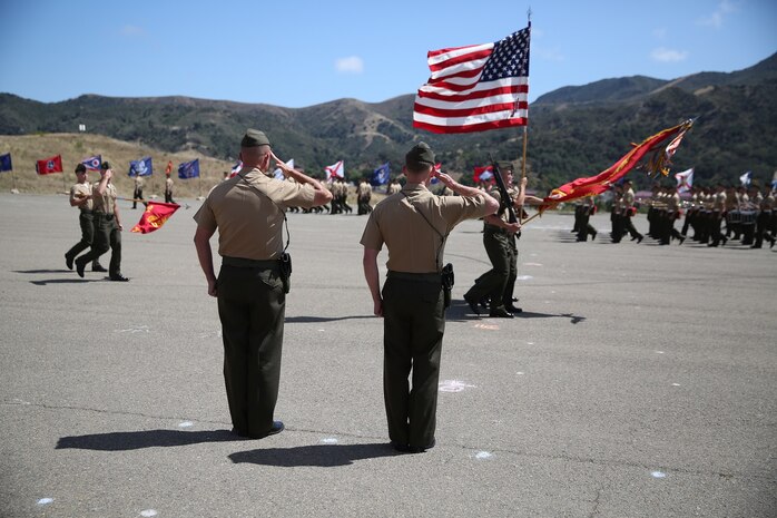 Lieutenant Col. Lance A. Jackola, previous battalion commander of 1st Battalion, 1st Marine Regiment, 1st Marine Division, and his successor Lt. Col. Steven M. Sutey, watch as the Marines and Sailors of 1st Battalion pass in review at the end of the change of command ceremony. Sutey has several past deployments with the 1st Marine Division and said he is proud to command and serve once again with the unit. (U.S. Marine Corps photo by Cpl. Carson A. Gramley/Released)