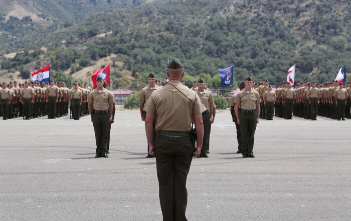 Lieutenant Col. Lance A. Jackola, battalion commander of 1st Battalion, 1st Marine Regiment, 1st Marine Division, inspects his Marines and Sailors one last time before relinquishing his command to his successor Lt. Col. Steven M. Sutey. Sutey has several past deployments with the 1st Marine Division and said he is proud to command and serve once again with the unit. (U.S. Marine Corps photo by Cpl. Carson A. Gramley/Released)