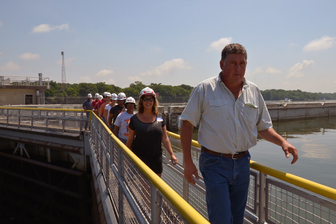 Charlie Bryan, lock master at the Old Hickory Lock in Hendersonville, Tenn., leads a group of teachers from the Stratford Magnet High School across the lock June 9, 2015. The high school teachers are using externships with the U.S. Army Corps of Engineers Nashville District to develop a Science, Technology, Engineering and Mathematics class curriculum.