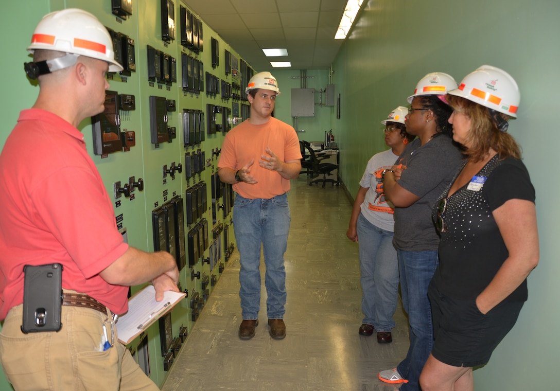 Jake Kennedy, senior electrician and Will Garner, hydropower engineer, both from the Old Hickory Power plant talks with teachers from the Stratford Magnet High School in Nashville, Tenn., July 9, 2015 about the  powerhouse’s many functions and management of the water. 