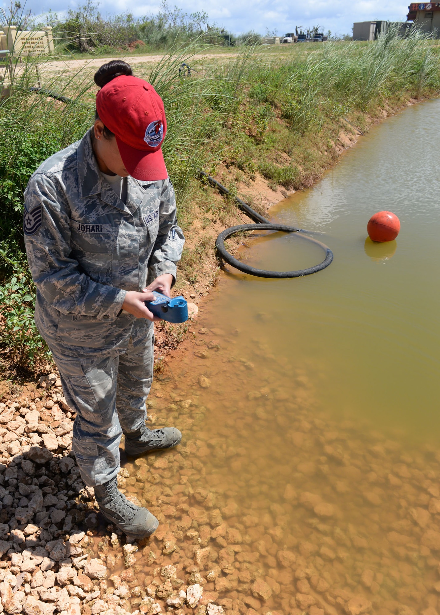 Tech. Sgt. Roshia Johari, the 554th RED HORSE NCO in charge of water and fuels systems maintenance contingency training, uses an ultrameter to test the quality of a water source June 9, 2015, at Andersen Air Force Base, Guam. The Reverse Osmosis Water Purification Unit’s purification process starts with finding a viable water source, which could be fresh, brackish or saltwater. (U.S. Air Force photo/Airman 1st Class Joshua Smoot)