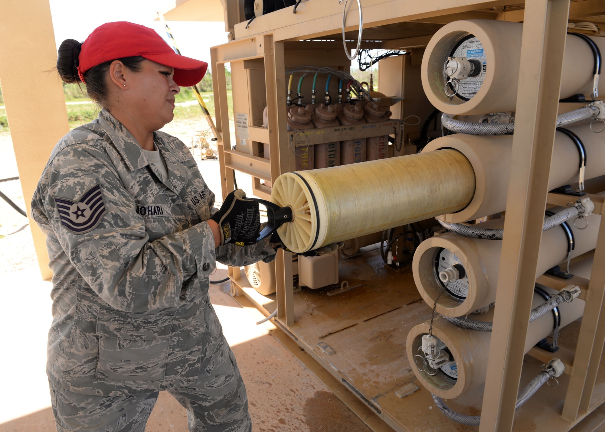 Tech. Sgt. Roshia Johari, the 554th RED HORSE NCO in charge of water fuels systems maintenance contingency training, uses an element extraction tool to pull elements from their vessels on a Reverse Osmosis Water Purification Unit June 9, 2015, at Andersen Air Force Base, Guam. Airmen are trained at Anderson AFB to be able to turn untested water into potable H2O using the ROWPU. (U.S. Air Force photo/Airman 1st Class Joshua Smoot)