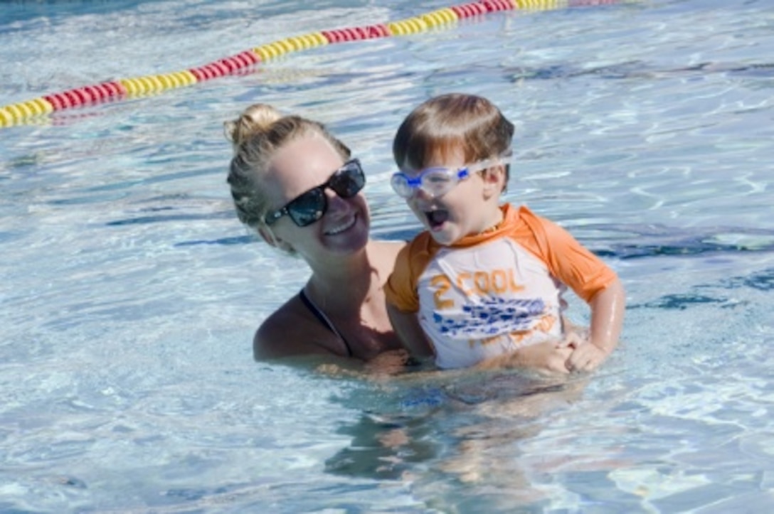 MARINE CORPS BASE HAWAII — L.J. Szalai, water safety instructor certified swim instructor, engages in a swimming lesson with Andrew Thiel, 3, at the base pool, June 9, 2015. Swimming lessons are available at the base pool during the summer. (U.S. Marine Corps photo by Kristen Wong/Released)
