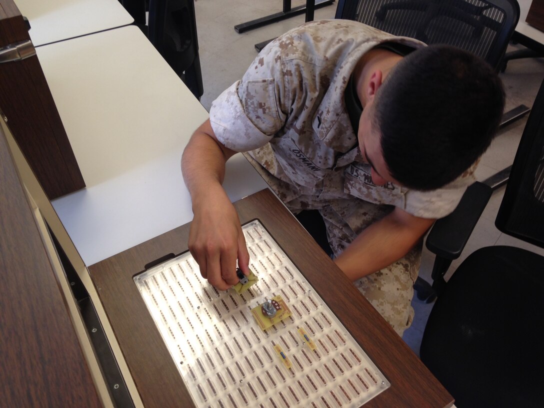 A Marine from BEEEST 7-15 conducts a practical application on AC theory.