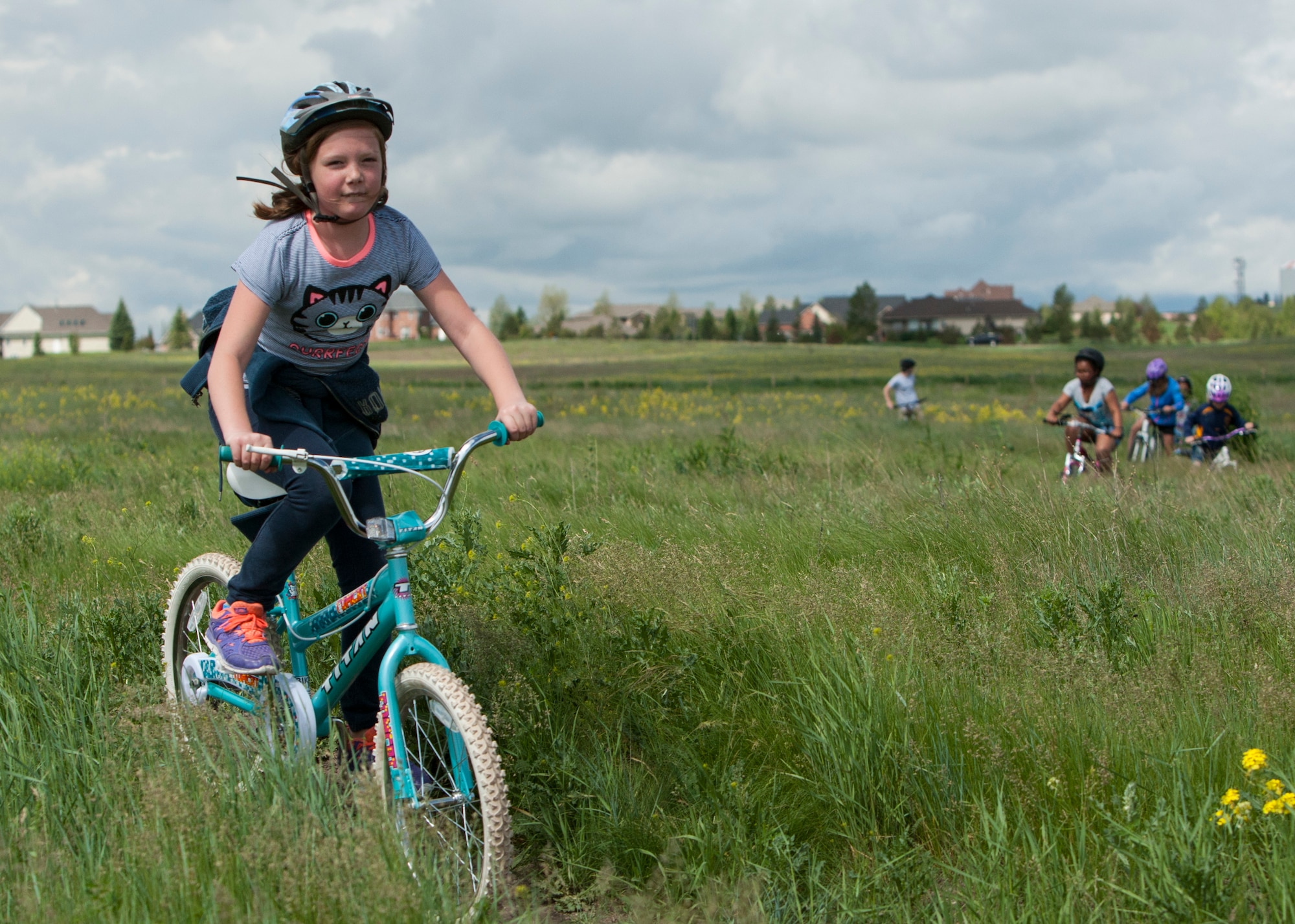 Baileigh Mitchell, 9, daughter of Master Sgt. Kenneth Mitchell, 90th Missile Security Forces Squadron, bikes through the trails on North Cheyenne Community Park, Cheyenne, Wyo., June 11, 2015. The biking was one of the activities hosted by Outdoor Recreation's Basic Recreation Adventure Training Camp from F.E. Warren Air Force Base. (U.S. Air Force photo by Lan Kim)