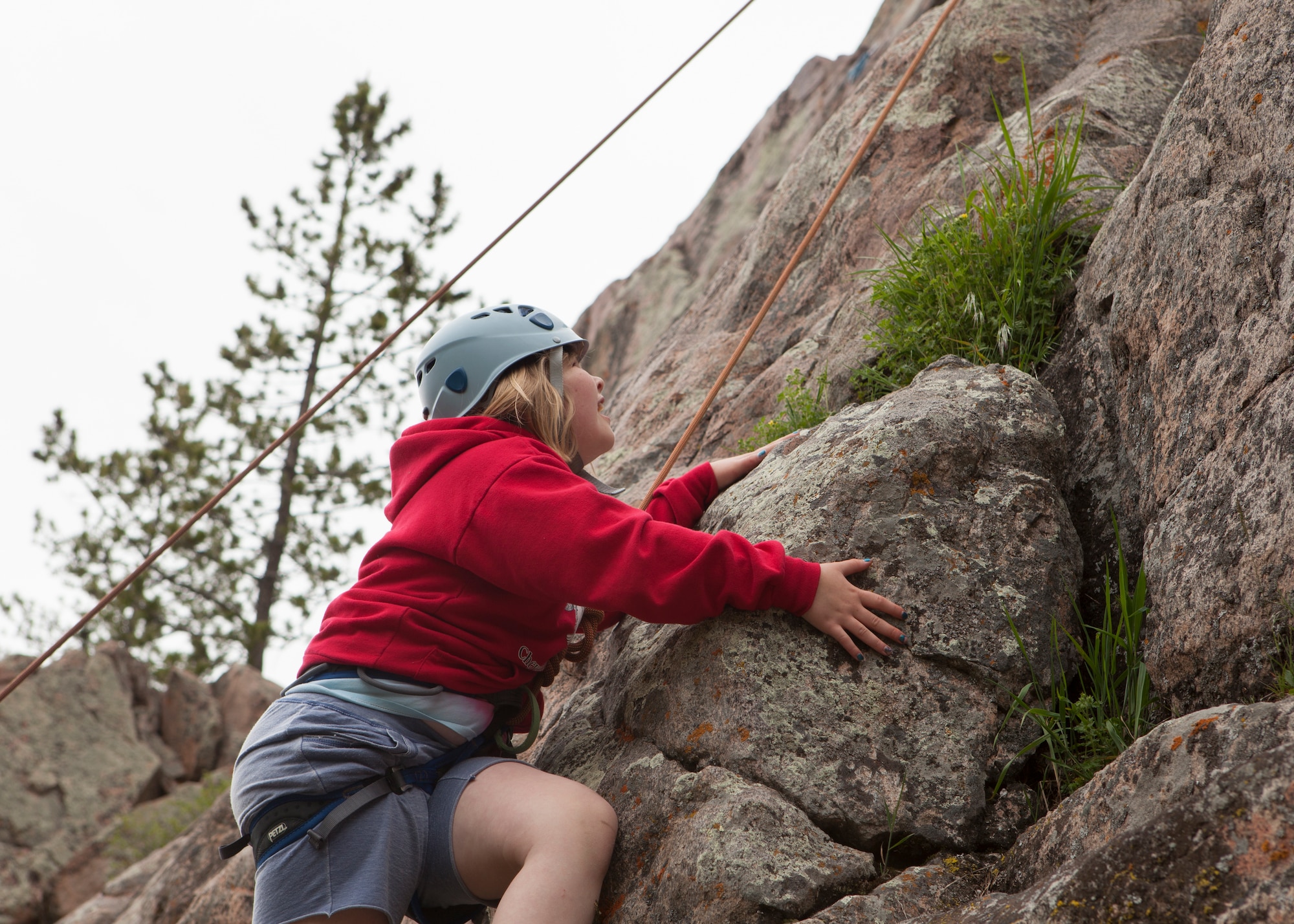Felicity Sakura, 9, daughter of Capt. Edith Sakura, 90th Missile Wing Public Affairs, and Gary Sakura, 90th Comptroller Squadron, climbs the Beehive Buttress at the Vedauwoo Recreation Area in Medicine Bow National Forest, Wyo., June 10, 2015. The climb was one of the activities hosted by Outdoor Recreation's Basic Recreation Adventure Training Camp from F.E. Warren Air Force Base. (U.S. Air Force photo by Lan Kim)