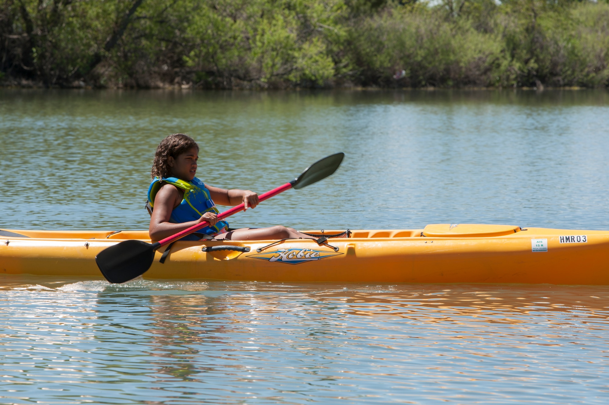 Olivia Marshall, 9, daughter of Capt. Lauren Rodgers, 90th Medical Support Squadron, practices her kayak skills on the base lake, F.E. Warren Air Force Base, Wyo., June 9, 2015. Olivia participated in Outdoor Recreation's  Basic Recreation Adventure Training Camp which included various outdoor activities on base and in the local area. (U.S. Air Force photo by Lan Kim)