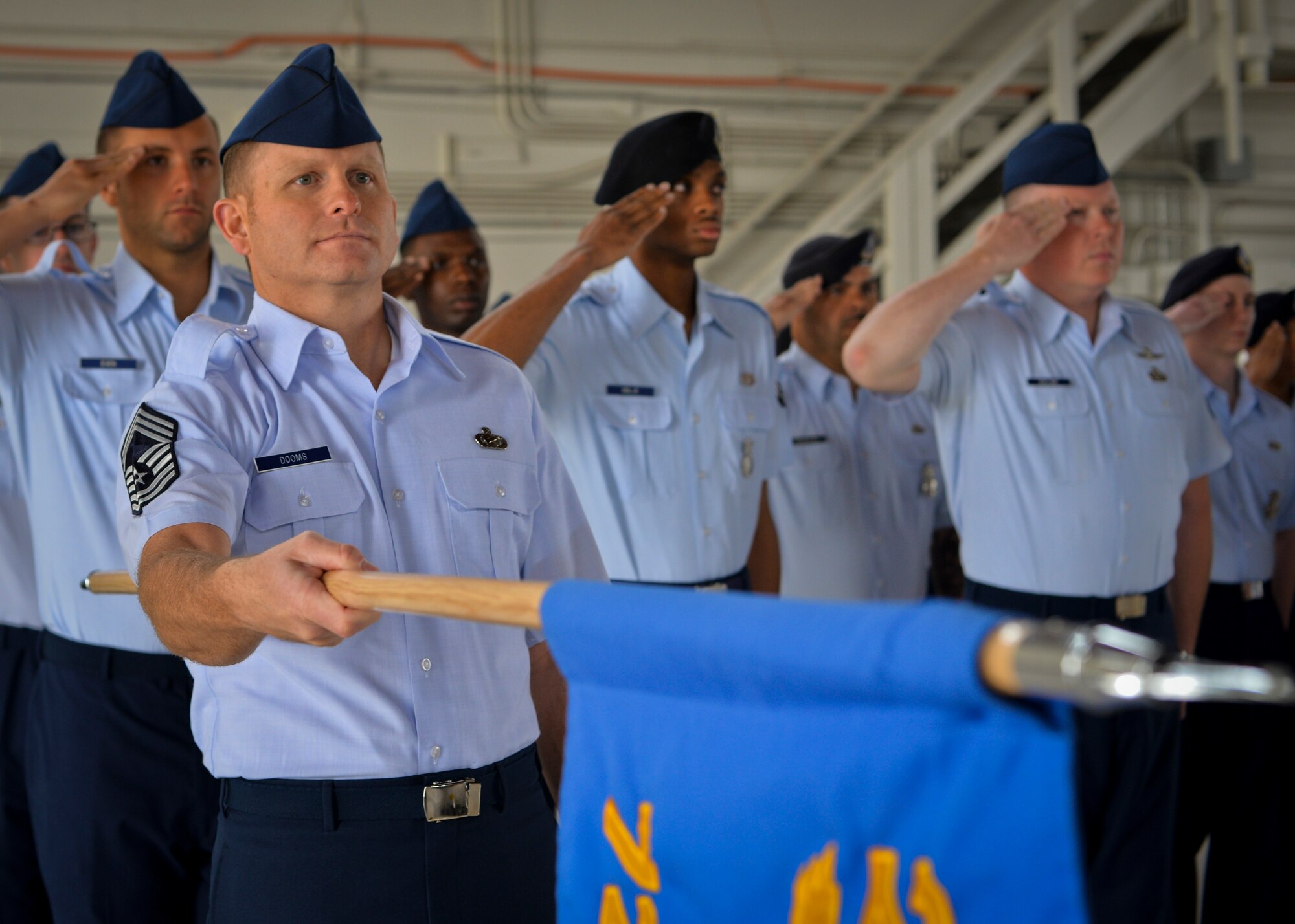 PETERSON AIR FORCE BASE, Colo. – Chief Master Sgt. Kevin Dooms, 721st Mission Support Group superintendent, renders a salute with the 721st MSG guidon during the wing change of command ceremony June 12 in hangar 140. Before taking command of the wing, Col. Douglas A. Schiess was Director of Space Forces, U.S. Air Forces Central Command, U.S. Central Command. (U.S. Air Force photo/Staff Sgt. J. Aaron Breeden)