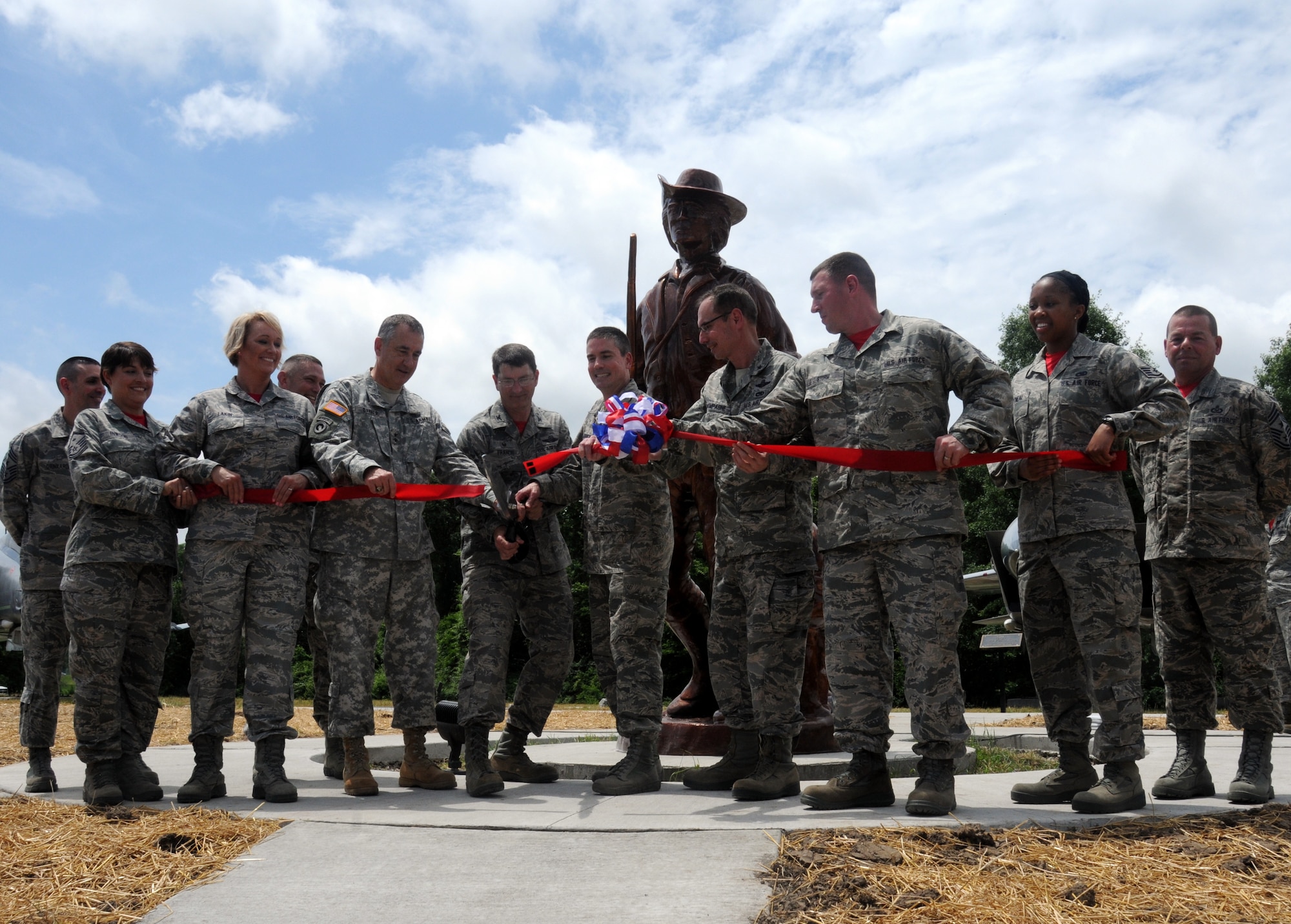 Airmen and officers of the 131st Bomb Wing and 509th Bomb Wing cut the ceremonial ribbon at the 131st Bomb Wing Heritage Park during the dedication ceremony at Whiteman Air Force Base, Missouri, June 12, 2015. Col. Michael Francis, 131st Bomb Wing commander, cut the ribbon to open the new park that hosts Whiteman’s newest static aircraft, along with Missouri Adjutant General Maj. Gen. Steve Danner, 509th Bomb Wing Commander Brig. Gen. Paul Tibbets IV, Brig. Gen. Greg Champagne, and Airmen of the 131st Bomb Wing.  (U.S. Air National Guard photo by Senior Airman Nathan Dampf)