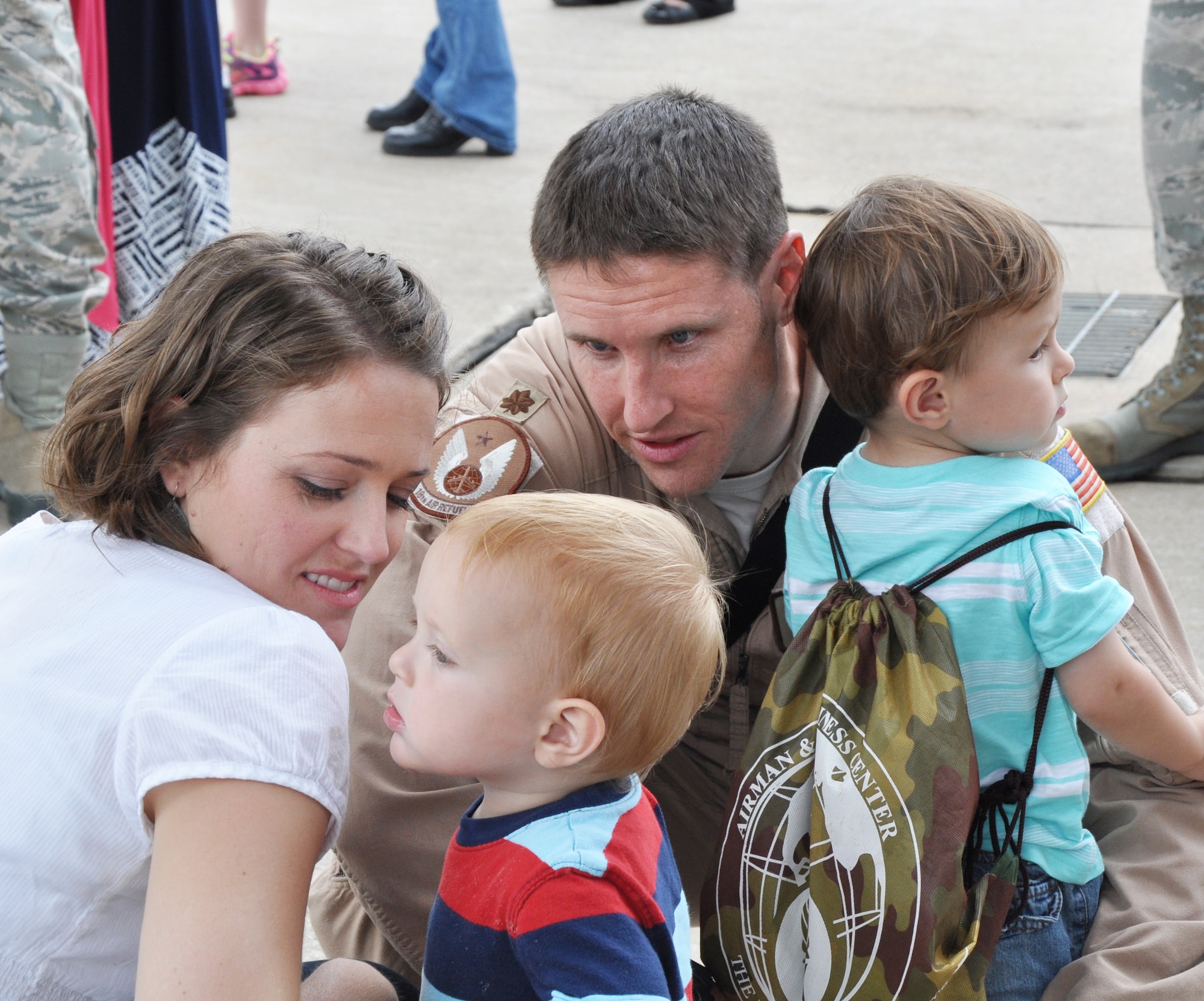 Maj. Daniel Mecham, 18th Air Refueling Squadron pilot, greets his spouse, Michelle, and their sons Dallin and Stephen, after returning from a deployment to Southwest Asia, June 12, 2015, at McConnell Air Force Base, Kan. During the deployment, the 931 ARG performed aircraft maintenance and filled other support roles. (U.S. Air Force photo by Tech. Sgt. Abigail Klein)