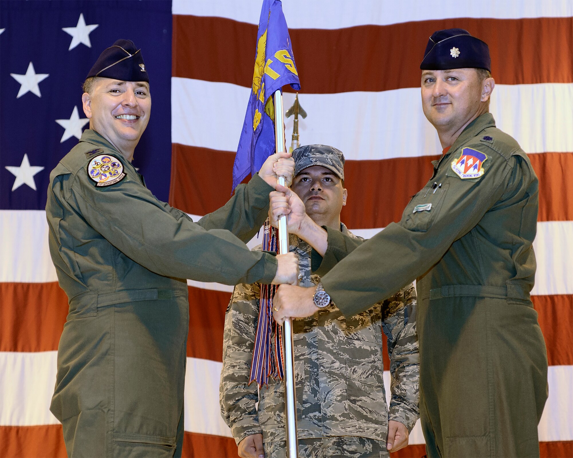 Lt. Col. Bryan Elder accepts the 8th Flying Training Squadron guidon from Col. John Cinnamon, the 71st Operations Group commander, during a change-of-command ceremony June 12 at Vance Air Force Base, Oklahoma. Elder assumed command from Lt. Col. Troy Henderson. (U.S. Air Force photo / David Poe)