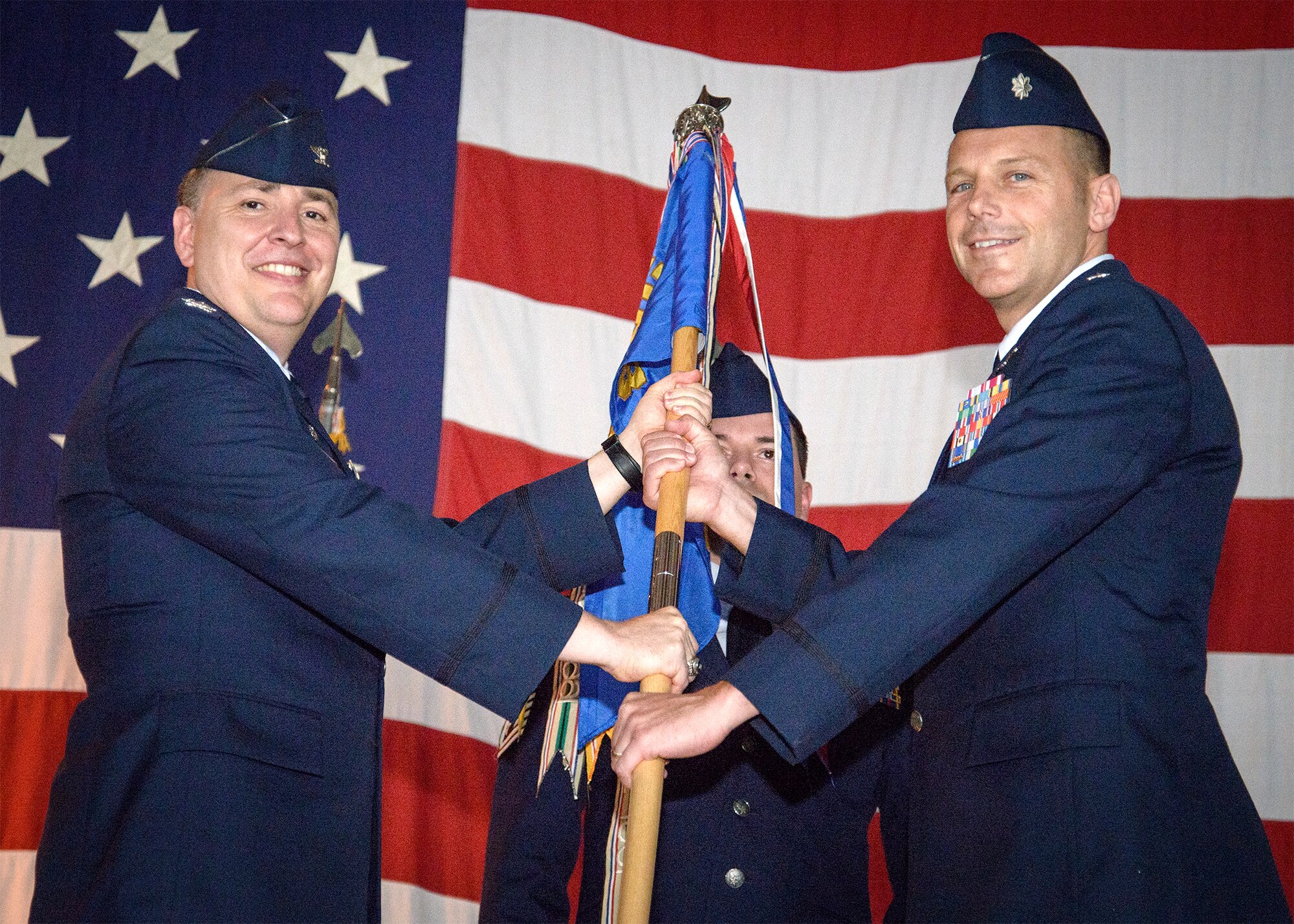 Lt. Col. Michael Maksimowicz accepts the 3rd Flying Training Squadron guidon from Col. John Cinnamon, the 71st Operations Group commander, during a change-of-command ceremony June 11 at Vance Air Force Base, Oklahoma. Masksimowicz took the reins from Lt. Col. Sean Martin. (U.S. Air Force photo/David Poe)