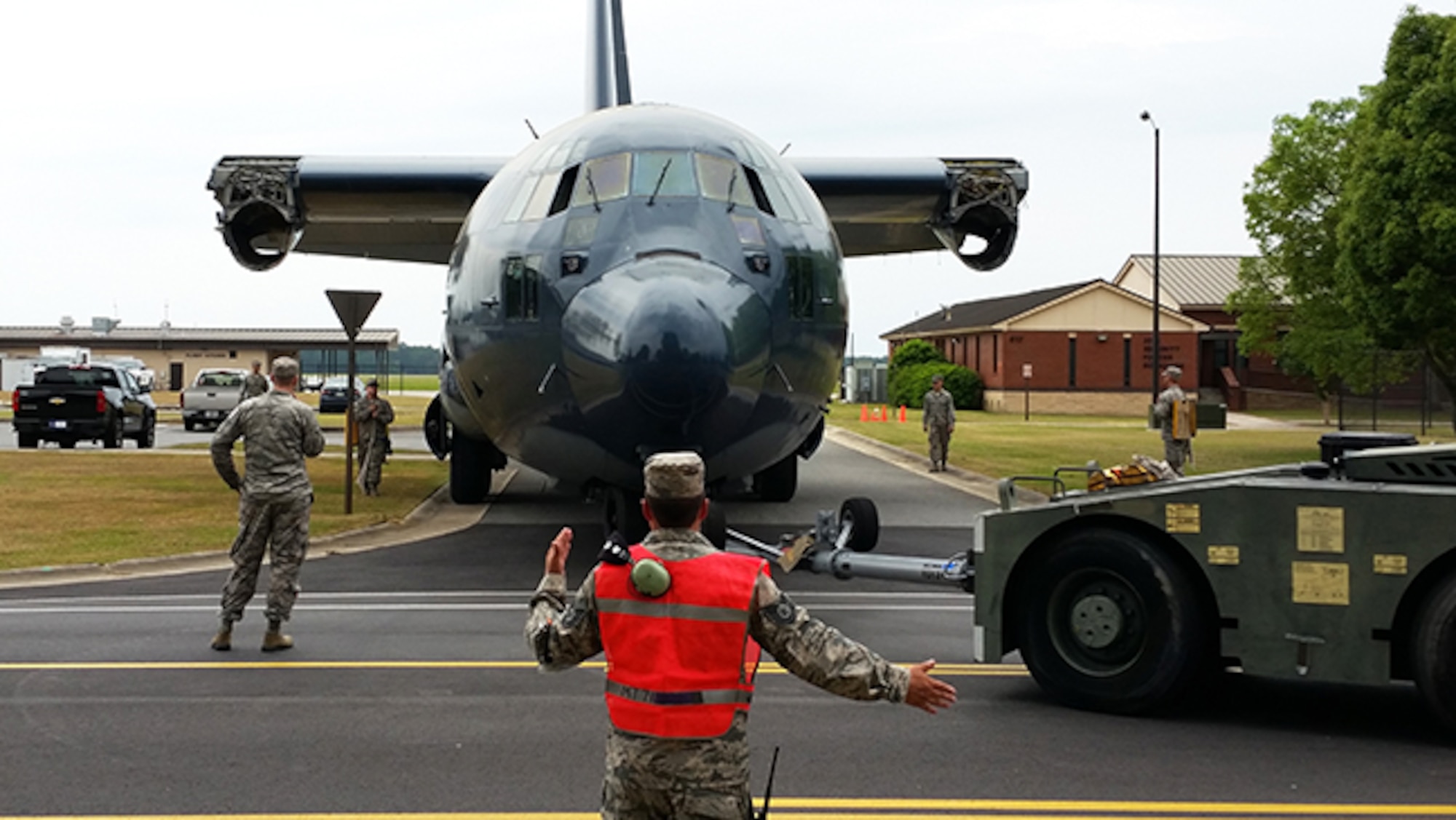 The 71st Aircraft Maintenance Unit paired with the 23d Civil Engineering Squadron to transport a retired HC-130P Combat King to the President George W. Bush Airpark May 14, 2015, at Moody Air Force Base, Ga. The 23d CES helped remove any obstacles such as tree branches or electrical posts during the move. (Courtesy photo)